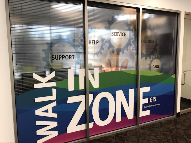 Perforated vinyl and opaque window film used to create a interior window display.